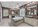 Luxurious bathroom with a soaking tub, dual vanities, decorative tile, and elegant lighting at 3011 E Morrison Ranch Pkwy, Gilbert, AZ 85296