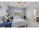 This bedroom features two beds, a ceiling fan, and a door to a bathroom at 3011 E Morrison Ranch Pkwy, Gilbert, AZ 85296