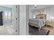 Inviting bedroom with a stylish bed, neutral tones, and a view into a second bedroom at 3011 E Morrison Ranch Pkwy, Gilbert, AZ 85296