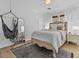 Bright bedroom with a comfortable bed, soft linens, and a modern hanging hammock at 3011 E Morrison Ranch Pkwy, Gilbert, AZ 85296