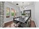 Elegant dining room with large windows, stylish lighting, and seating for ten at 3011 E Morrison Ranch Pkwy, Gilbert, AZ 85296