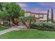 Charming two-story home with lush landscaping, stone accents, and a welcoming paver walkway at 3011 E Morrison Ranch Pkwy, Gilbert, AZ 85296