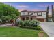 Charming two-story home with a well-manicured lawn, beautiful landscaping, and attached two-car garage at 3011 E Morrison Ranch Pkwy, Gilbert, AZ 85296