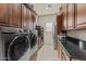 Convenient laundry room with modern appliances, storage, and counter space at 3011 E Morrison Ranch Pkwy, Gilbert, AZ 85296