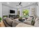 Cozy living room with comfortable seating, a large window, and a modern entertainment center at 3011 E Morrison Ranch Pkwy, Gilbert, AZ 85296