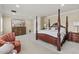 Spacious main bedroom boasts a four-poster bed, soft carpet, and a classic dresser at 3011 E Morrison Ranch Pkwy, Gilbert, AZ 85296