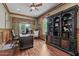 Well-appointed home office with custom built-ins, desk, and natural light at 3011 E Morrison Ranch Pkwy, Gilbert, AZ 85296
