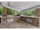 Outdoor kitchen with built-in grill, stainless steel cabinets, and brick surround at 3011 E Morrison Ranch Pkwy, Gilbert, AZ 85296