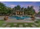 Beautiful pool area with a spa, a pergola with a fireplace, and lush landscaping at 3011 E Morrison Ranch Pkwy, Gilbert, AZ 85296