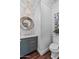 Charming powder room featuring a decorative mirror, modern vanity, and stylish light fixture at 3011 E Morrison Ranch Pkwy, Gilbert, AZ 85296
