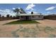 Spacious backyard featuring artificial turf and rock landscaping with perimeter block fencing at 3150 E Corrine Dr, Phoenix, AZ 85032