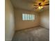 Cozy bedroom with plush carpet, a ceiling fan, and a sunlit window at 3150 E Corrine Dr, Phoenix, AZ 85032