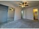 Bright bedroom features neutral carpet, fan, and large closet with mirrored sliding doors at 3150 E Corrine Dr, Phoenix, AZ 85032