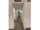 Hallway area with wood-style flooring, white walls and access to the bathroom and bedrooms at 3150 E Corrine Dr, Phoenix, AZ 85032
