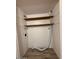 Functional utility room featuring wooden shelves and a vent for a dryer at 3150 E Corrine Dr, Phoenix, AZ 85032