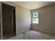 Bedroom featuring a window, drywall walls, concrete floor, and an open closet at 32123 N Lone Rancher Way, San Tan Valley, AZ 85140
