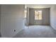 Bedroom featuring a window, drywall walls, and a smooth concrete floor at 32123 N Lone Rancher Way, San Tan Valley, AZ 85140