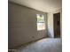 Bedroom featuring a window, drywall walls, concrete floor, and an open closet at 32123 N Lone Rancher Way, San Tan Valley, AZ 85140