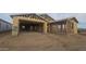 New home under construction with wood framing and a spacious two-car garage at 32123 N Lone Rancher Way, San Tan Valley, AZ 85140