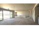 Spacious living room featuring smooth concrete floors, drywall walls, and access to the backyard at 32123 N Lone Rancher Way, San Tan Valley, AZ 85140