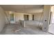 Spacious living room featuring smooth concrete floors, drywall walls, and access to the backyard at 32123 N Lone Rancher Way, San Tan Valley, AZ 85140