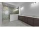 Modern bathroom featuring a double vanity with quartz countertops and a spacious tiled walk-in shower at 32497 N 135Th Dr, Peoria, AZ 85383
