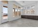 Bright dining room featuring a modern chandelier, ample natural light, and built-in cabinets at 32497 N 135Th Dr, Peoria, AZ 85383
