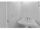Clean powder room featuring a pedestal sink and minimal design at 32497 N 135Th Dr, Peoria, AZ 85383