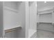 Organized walk-in closet with built-in shelving and ample storage space for clothes and accessories at 32497 N 135Th Dr, Peoria, AZ 85383
