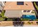 Aerial view highlighting a pool, covered patio, solar panels, and manicured landscaping at 35756 N Clementine Trl, San Tan Valley, AZ 85140