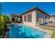 Backyard featuring a pool, covered patio with outdoor seating, and lush landscaping at 35756 N Clementine Trl, San Tan Valley, AZ 85140
