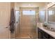 Bathroom with a glass enclosed shower featuring tile walls and flooring plus modern hardware at 35756 N Clementine Trl, San Tan Valley, AZ 85140