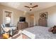 Bedroom with ceiling fan, television, sitting chair and lots of natural light at 35756 N Clementine Trl, San Tan Valley, AZ 85140
