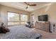 Bedroom featuring natural light, ceiling fan, and a cozy sitting area with a comfortable armchair at 35756 N Clementine Trl, San Tan Valley, AZ 85140