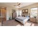 Sunlit bedroom featuring natural light, ceiling fan, and classic furnishings at 35756 N Clementine Trl, San Tan Valley, AZ 85140