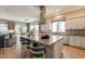 Open kitchen featuring a large island with breakfast bar seating and stainless steel hood vent at 35756 N Clementine Trl, San Tan Valley, AZ 85140