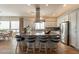 Spacious kitchen featuring white cabinets, a center island with barstool seating, and stainless steel appliances at 35756 N Clementine Trl, San Tan Valley, AZ 85140