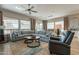 Bright living room featuring a large gray sectional, contemporary decor, and lots of natural light at 35756 N Clementine Trl, San Tan Valley, AZ 85140