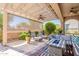 Inviting covered patio featuring lounge chairs, ceiling fans, and a cozy seating area with a fire pit at 35756 N Clementine Trl, San Tan Valley, AZ 85140