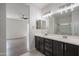 Bright bathroom featuring a double vanity with dark cabinets and modern lighting at 4205 W Maggie Dr, San Tan Valley, AZ 85144