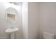 Pedestal sink and toilet in a well lit, neutral half bathroom at 4205 W Maggie Dr, San Tan Valley, AZ 85144