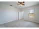 Bright bedroom with neutral carpet, ceiling fan, window, and closet access at 4205 W Maggie Dr, San Tan Valley, AZ 85144