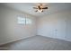 This bedroom features carpet, a ceiling fan, and a window for natural light at 4205 W Maggie Dr, San Tan Valley, AZ 85144