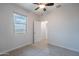 Neutral bedroom features a large window and doorway to another room at 4205 W Maggie Dr, San Tan Valley, AZ 85144