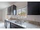 Bright kitchen with a large window over the sink, complemented by granite countertops and modern fixtures at 4205 W Maggie Dr, San Tan Valley, AZ 85144