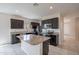 Modern kitchen with a large center island, granite countertops, dark cabinets, and stainless steel appliances at 4205 W Maggie Dr, San Tan Valley, AZ 85144
