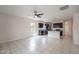 Open-concept living room with tile flooring flowing into a modern kitchen with dark cabinetry and stainless steel appliances at 4205 W Maggie Dr, San Tan Valley, AZ 85144