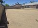 Wide backyard featuring desert landscaping with block wall and house on the right side at 5139 E Tano St, Phoenix, AZ 85044