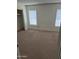 Bedroom with neutral carpet, natural light, and a large sliding door closet at 5139 E Tano St, Phoenix, AZ 85044