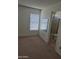 Carpeted bedroom with a window and a view into the bathroom at 5139 E Tano St, Phoenix, AZ 85044